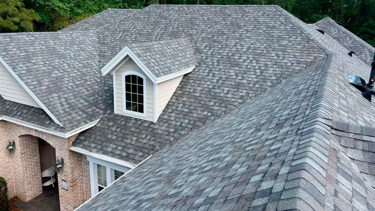 Aerial view of a finished architectural shingle roof on a large home