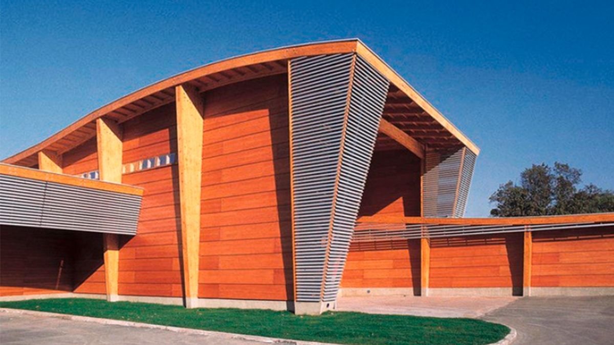 Curved architectural metal roof on a timber-framed building