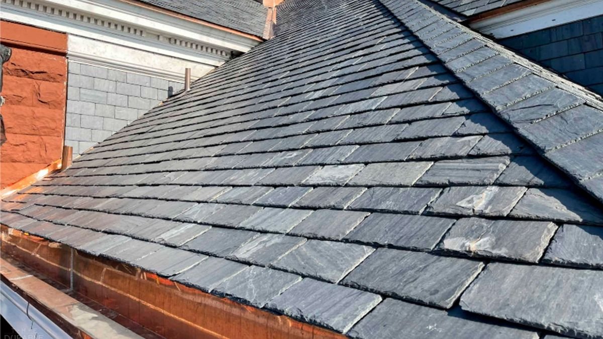 Natural slate roof with copper gutter on a historic building